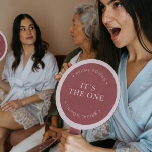Bridesmaids in robes with signs celebrating pre-wedding excitement.