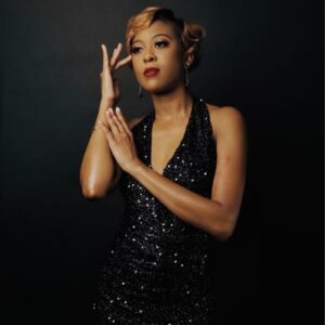 a woman in a black dress posing for a picture